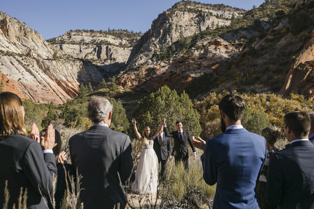 Just married couple celebrate with their immediate families in the Utah desert