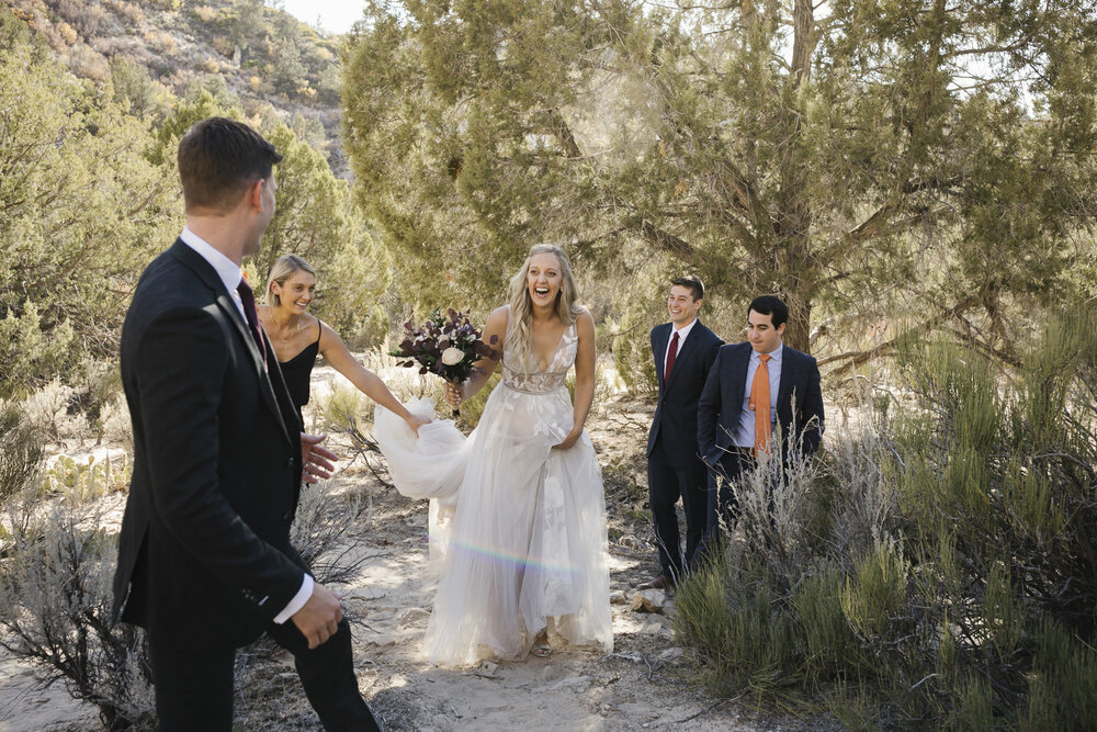 Bride looks joyfully at her groom immediately after their ceremony in the desert in Utah