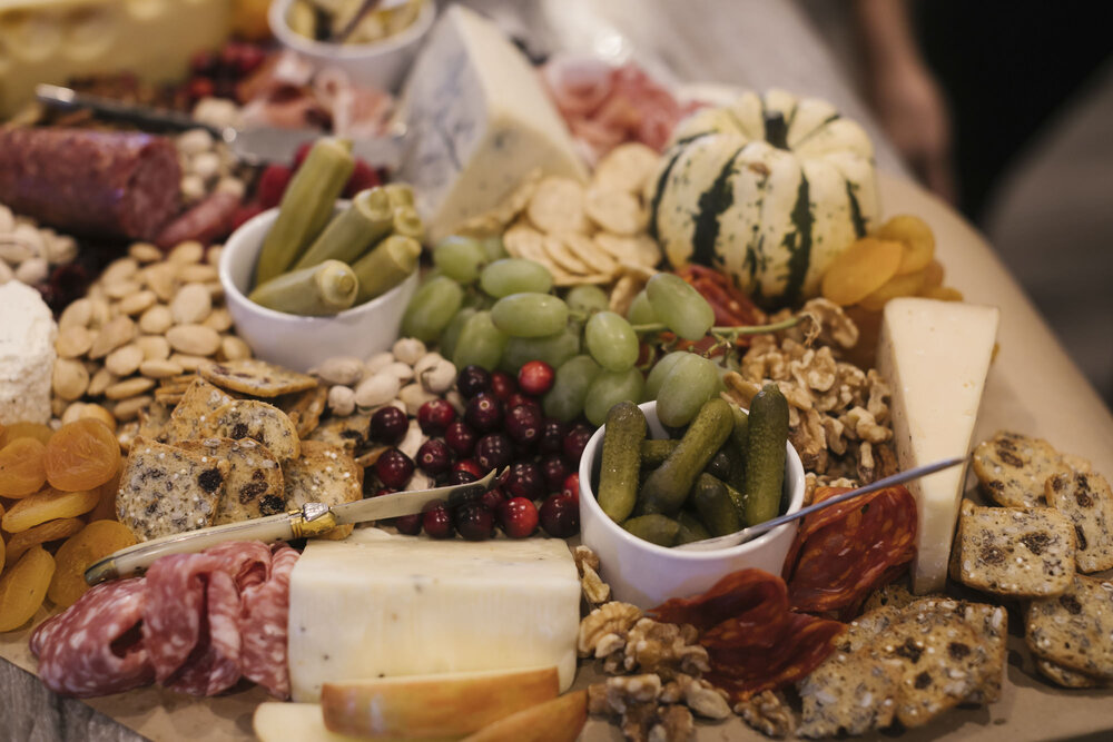Fall charcuterie board made by the bride's sister with grapes, cheese, and salami