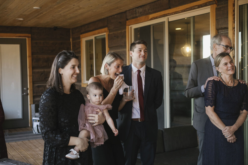 Family smiles and laughs as the bride dances with her dad