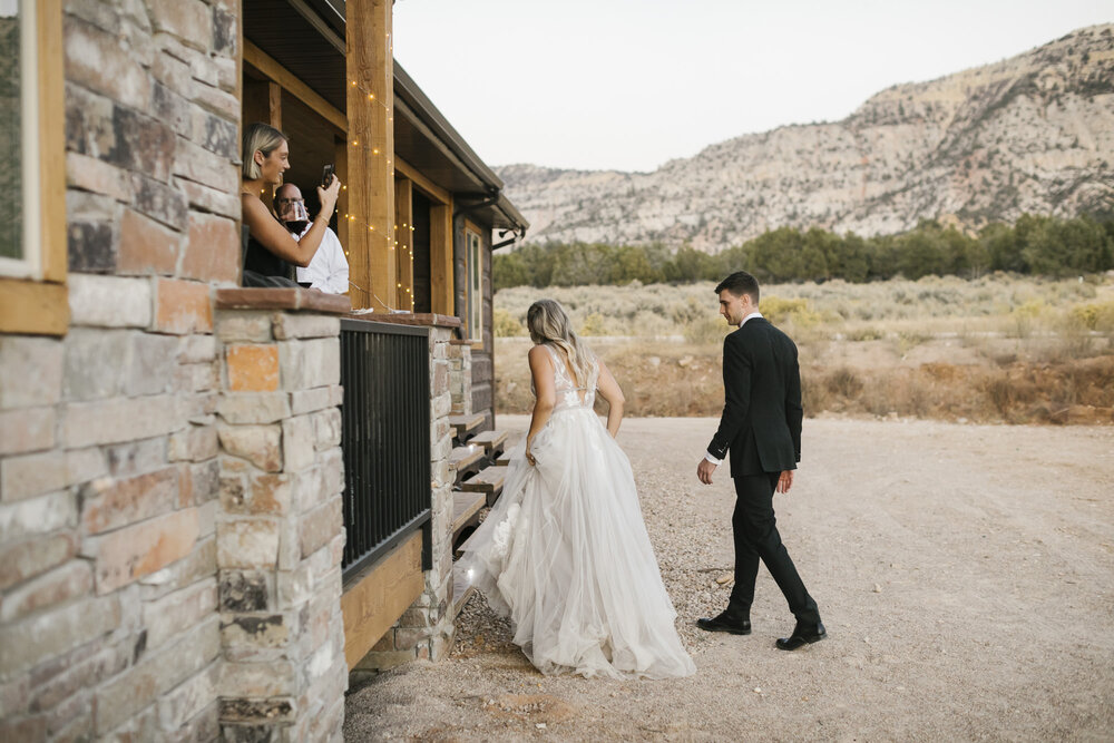 Wedding couple head back inside to their reception outside of Zion during their Utah desert wedding