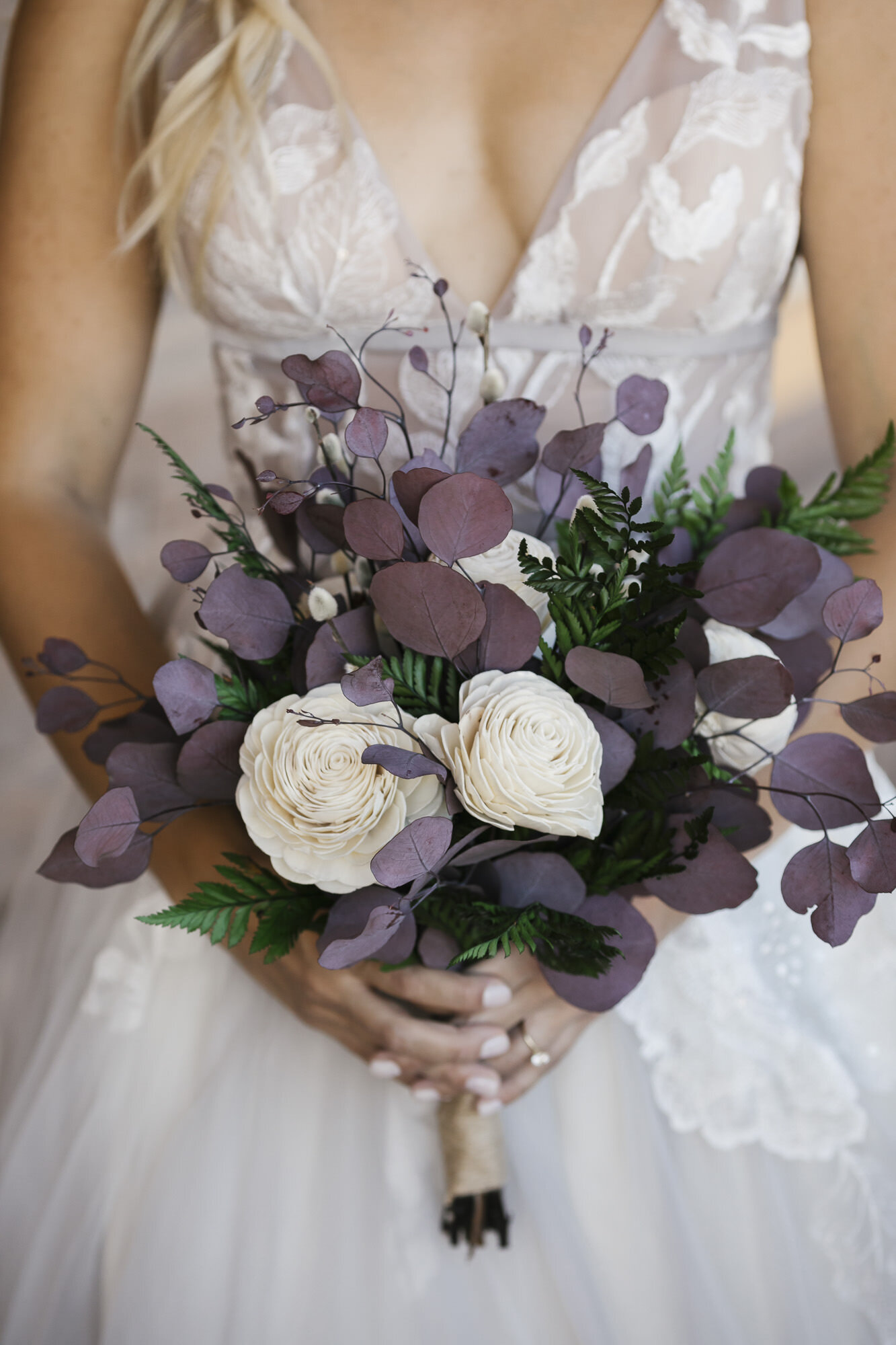 Detail shot of the bride's artificial flower bouquet handmade by her mother