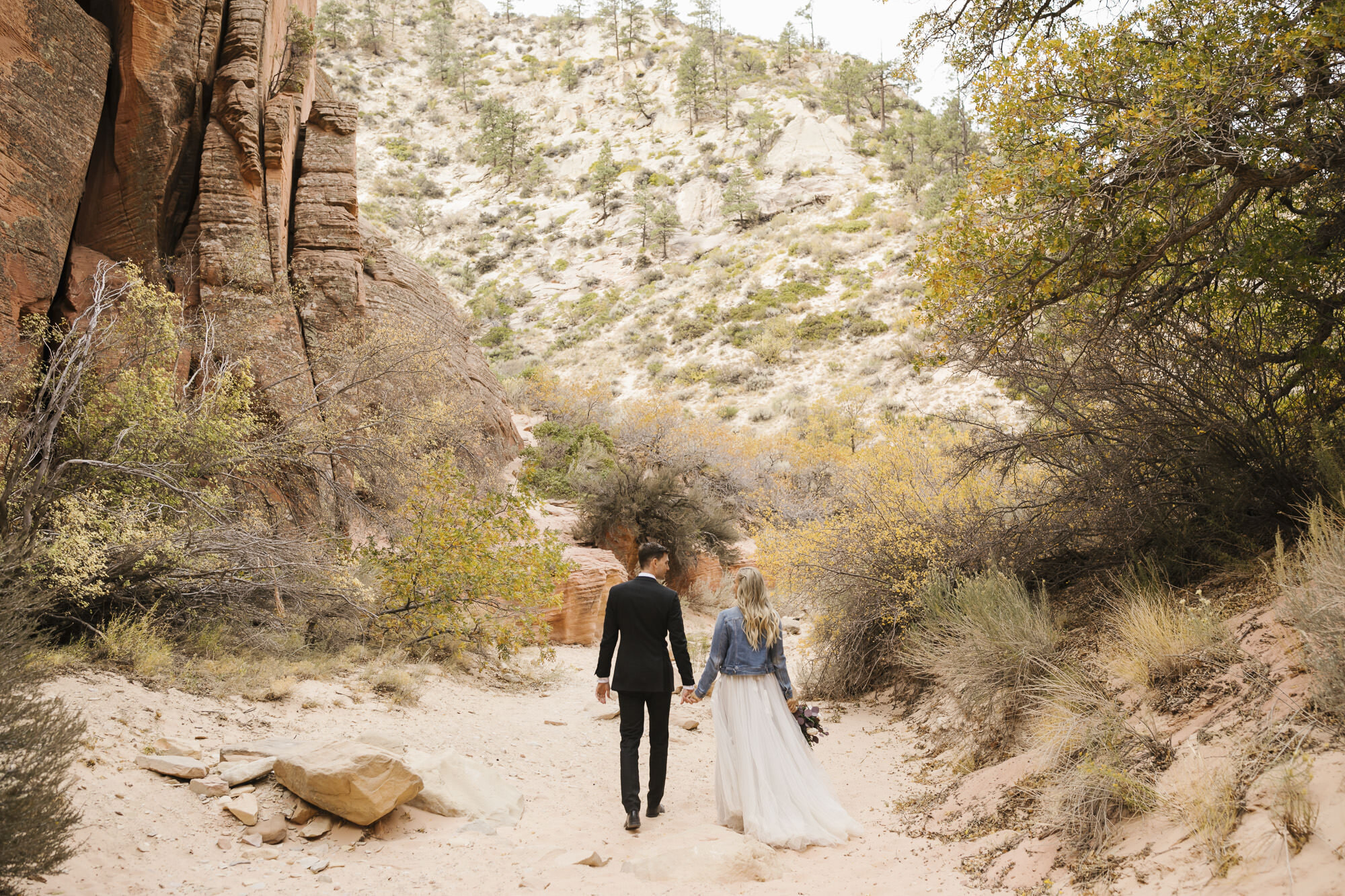 Couple walk together during their day-after wedding portraits in the Utah desert