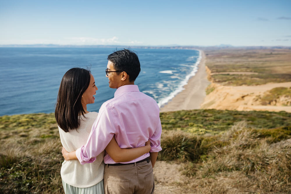 Couple portraits overlooking beach in Point Reyes California