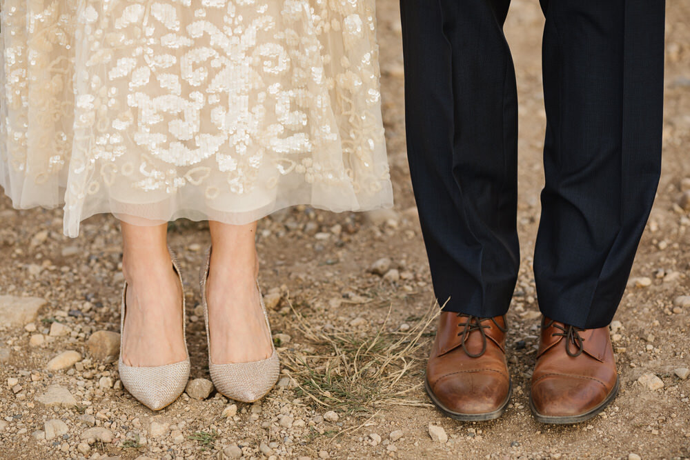 Point Reyes elopement couple's wedding shoes on the dirt trail