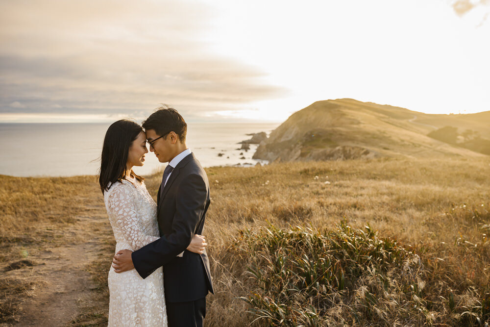 Wedding couple hold each other close during their elopement in Point Reyes