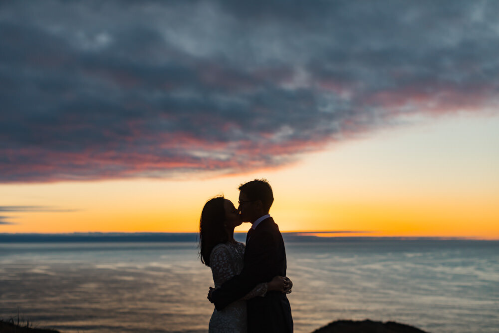 Wedding couple kiss at sunset in Point Reyes