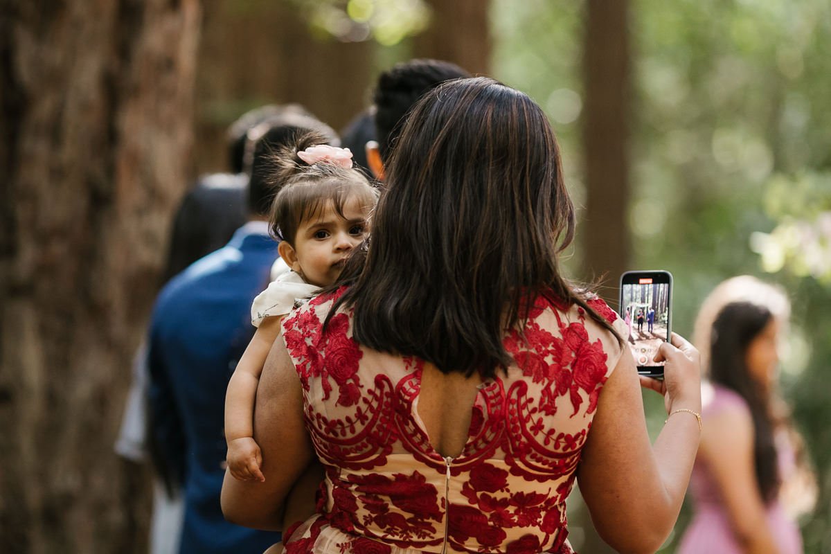 Mom and baby enjoy their friend's redwood forest elopement