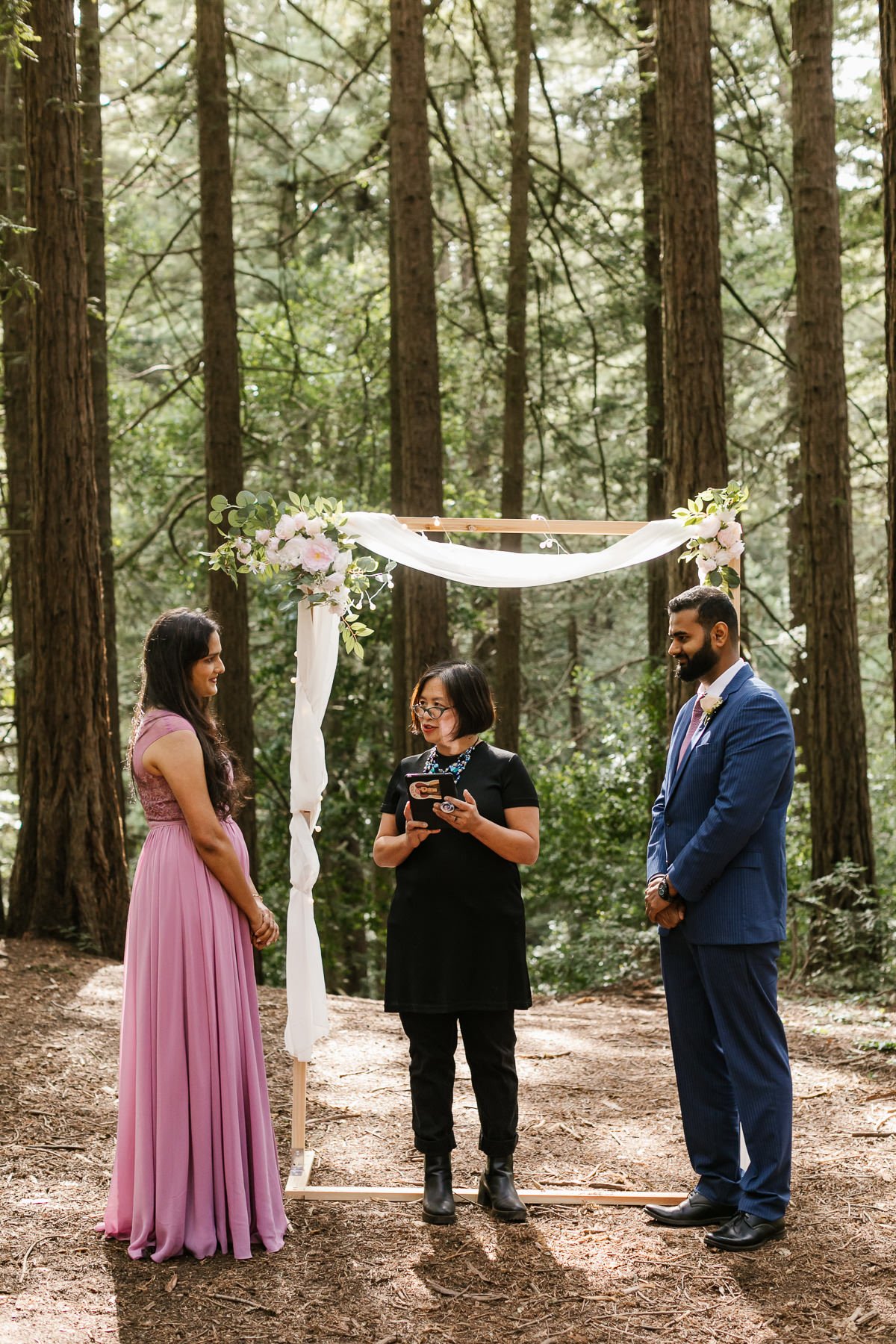 Officiant and couple during a redwood forest elopement in Joaquin Miller Park
