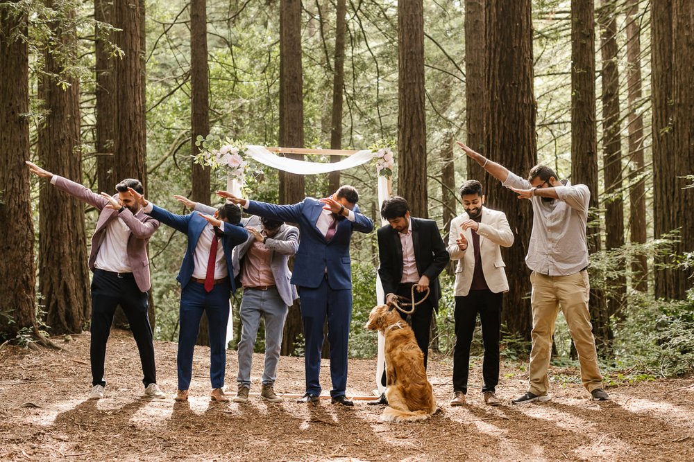 Groom and his friends dab in group wedding photo in the redwoods
