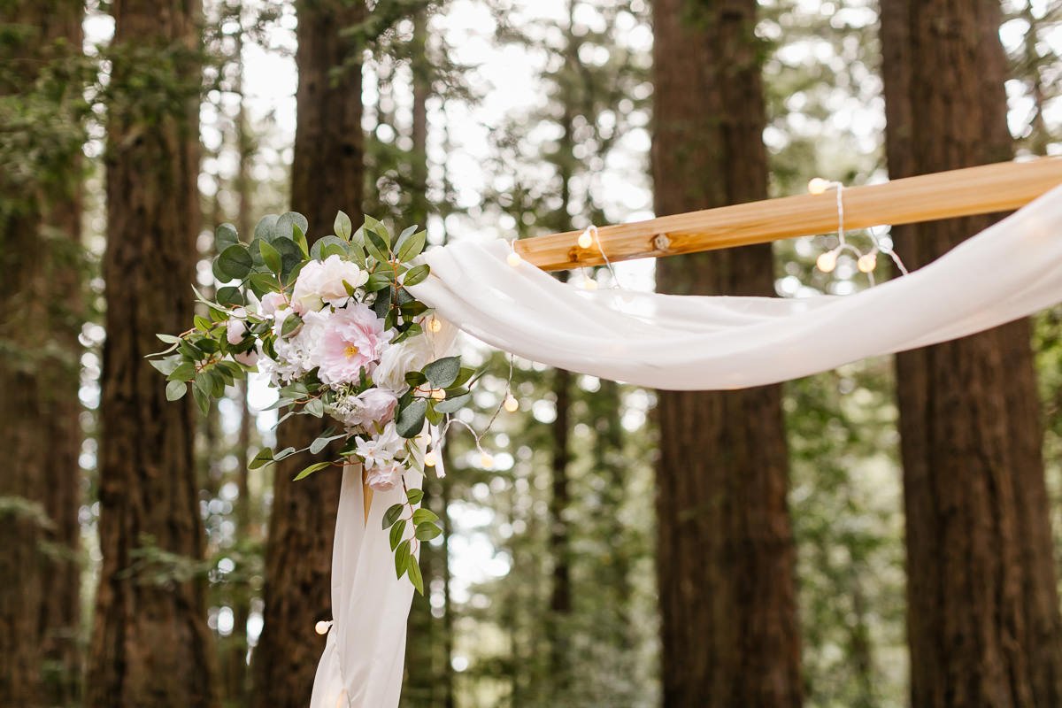 Detail of ceremony arch at couple's redwood forest elopement