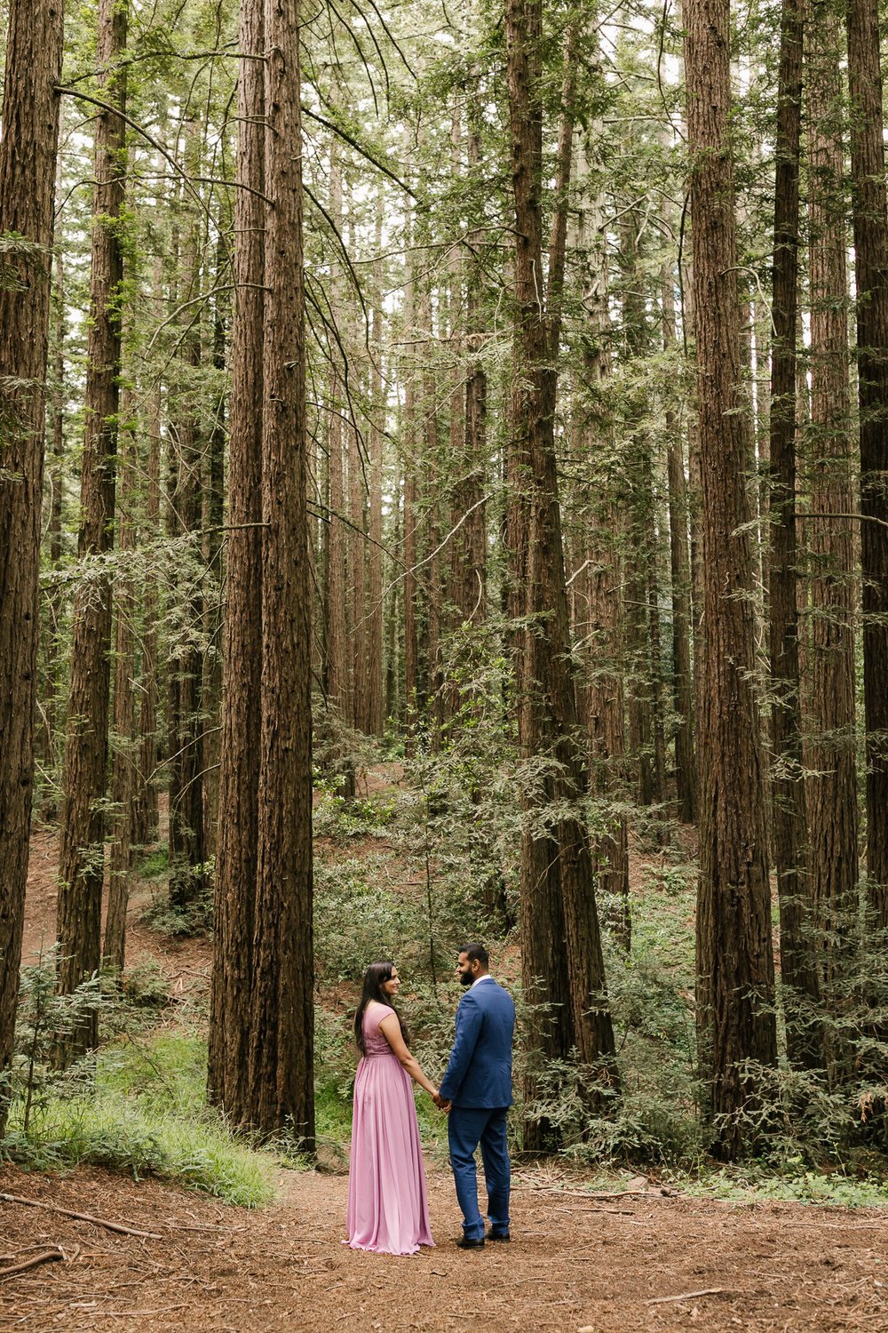 Couple stand among the trees at their redwood forest elopement in California’s Joaquin Miller Park