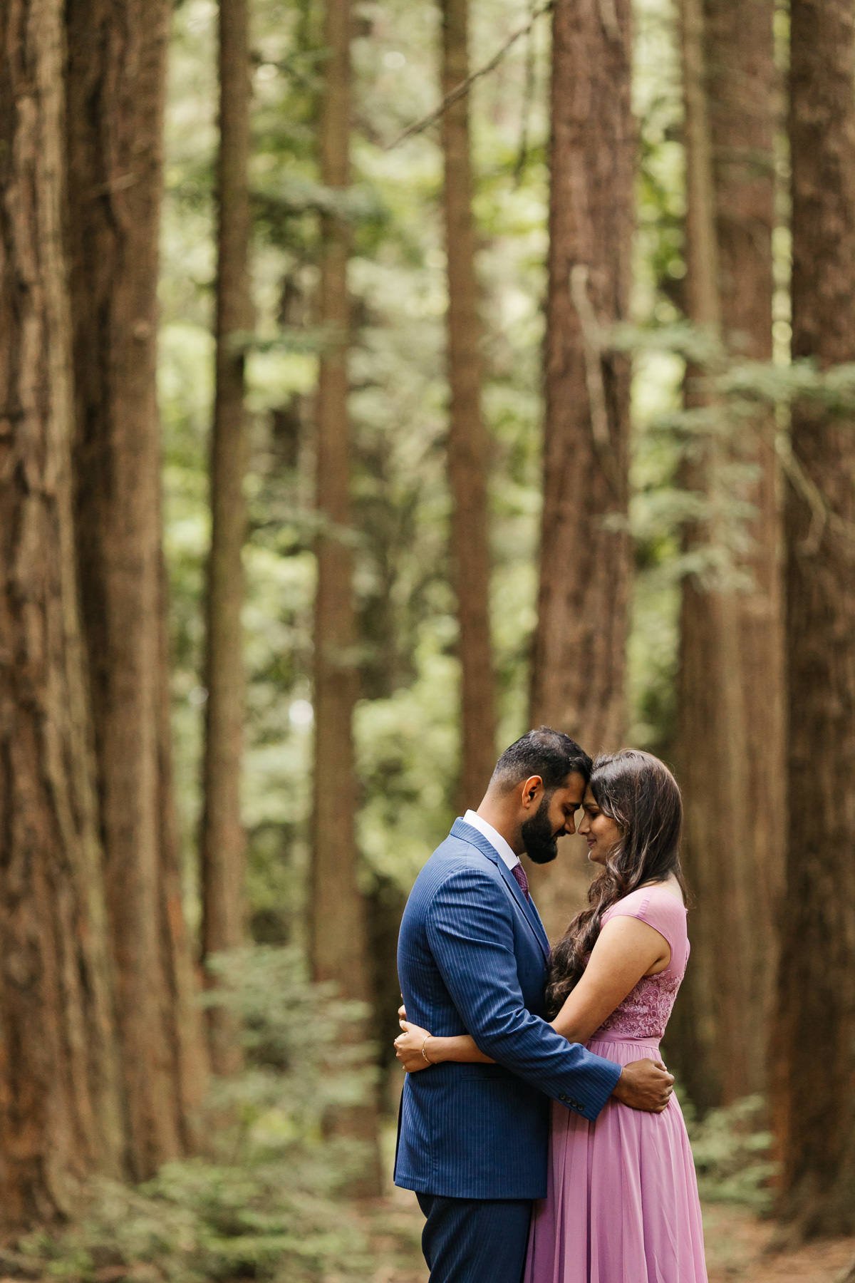 Wedding couple hold each other during portraits at their redwood forest elopement