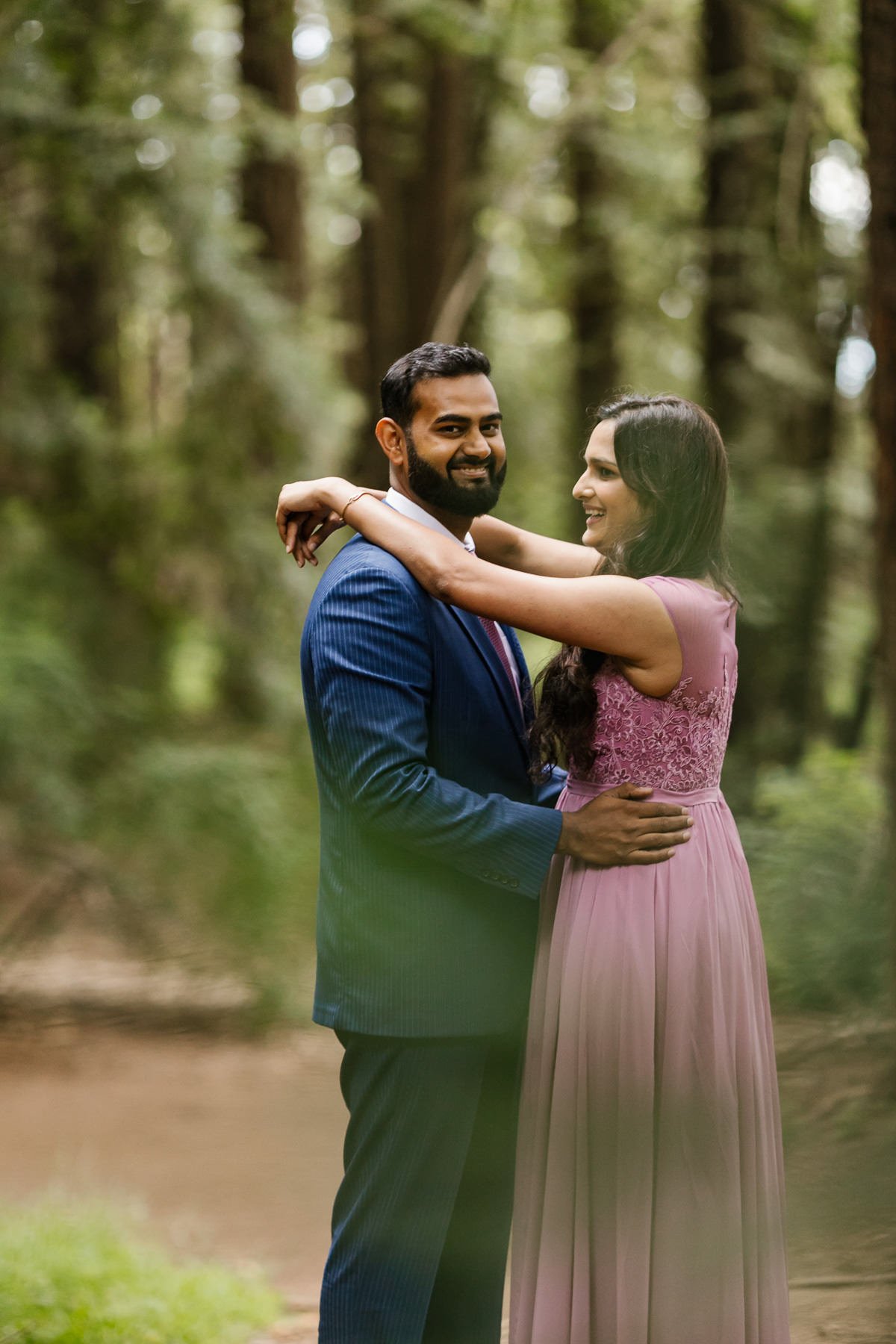 Wedding couple laughs during portraits at their redwood forest elopement