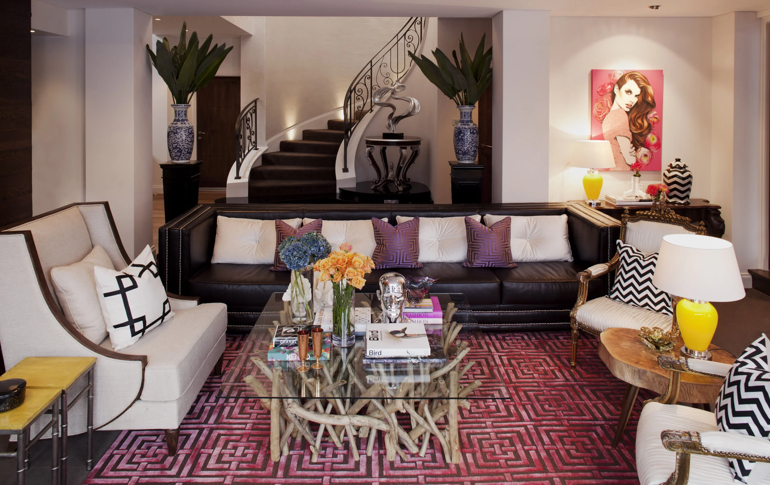 Luxury Perth living room featuring custom furnishings, sculptural coffee table, statement staircase, designer lighting and contemporary residential styling.