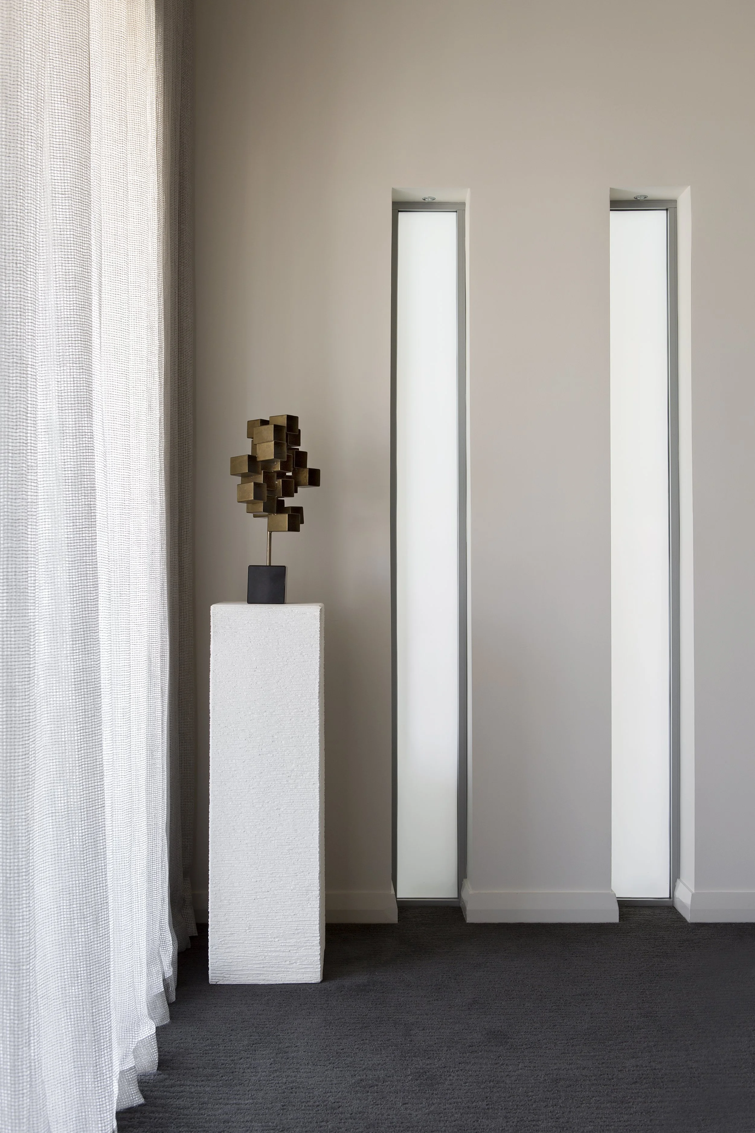 Architectural detail within the master bedroom at Arabella Residence featuring soft neutral finishes, floor-to-ceiling sheer curtains, sculptural décor and minimalist styling, creating a calm and sophisticated retreat designed by Luis La Pegna.
