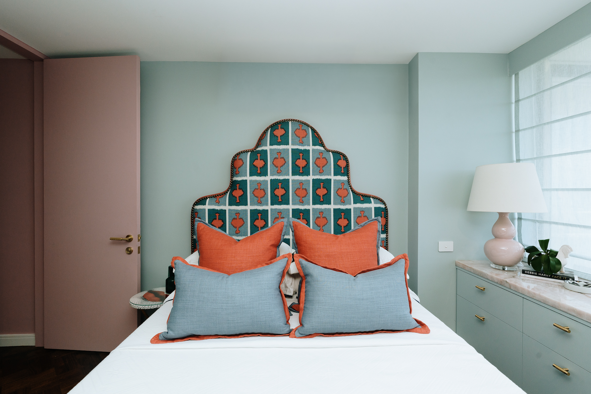 Luxury bedroom at Onslow Residence featuring a bespoke upholstered headboard, custom joinery, layered textiles and contemporary residential interior design in Sydney.