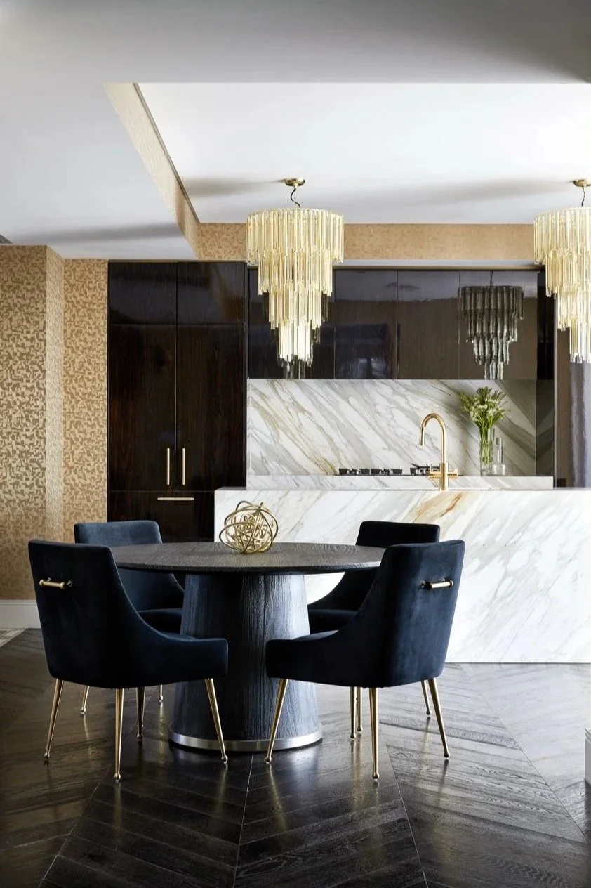 Sophisticated penthouse interior at Burwood Residence showcasing a marble kitchen, custom timber cabinetry, layered textures and contemporary dining furnishings.