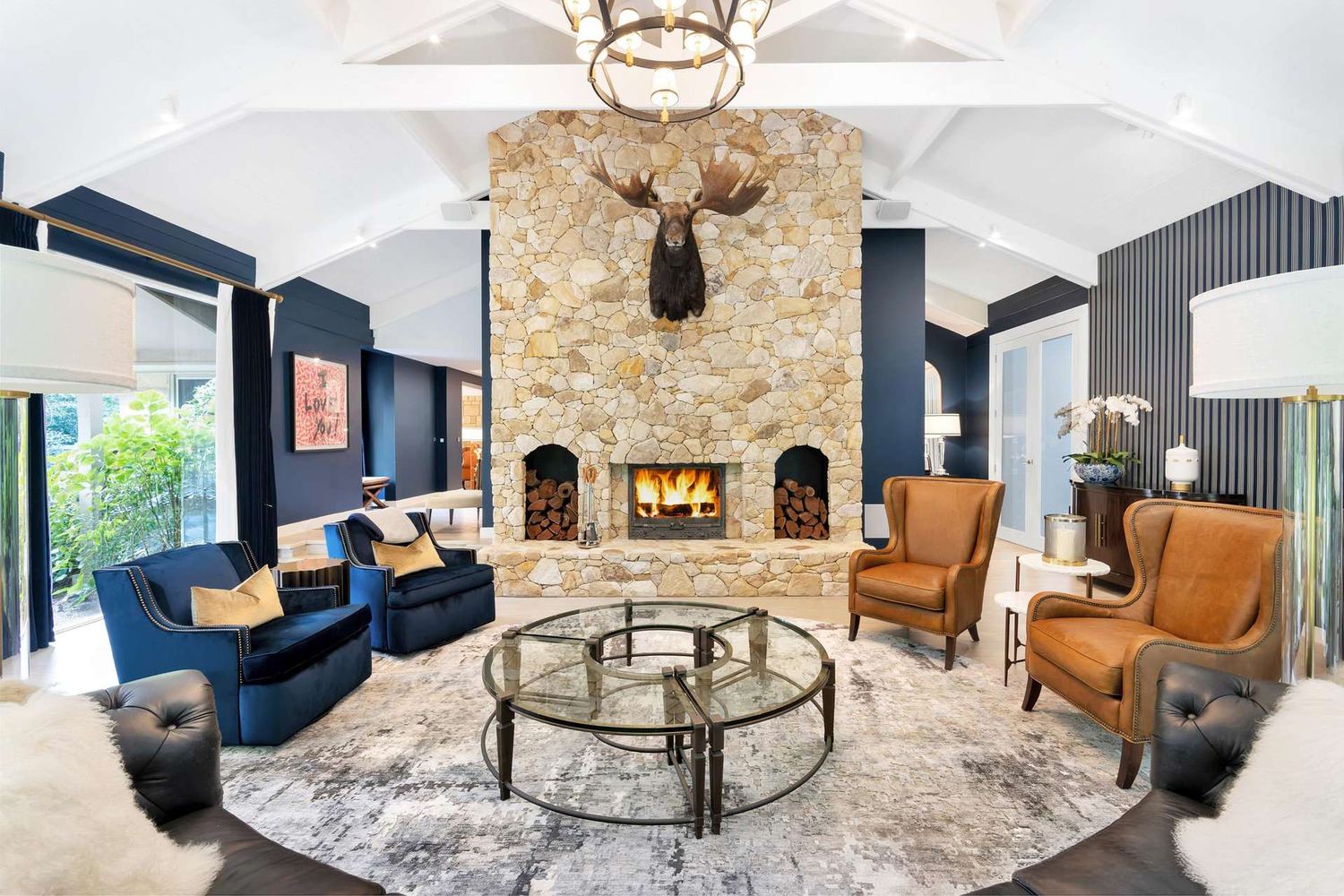 Pearsons Residence living room with a stone fireplace, by LLP Design