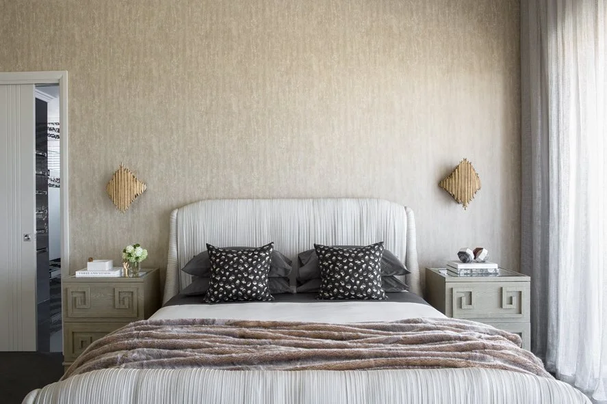 Luxury bedroom at Arabella Residence in North Coogee featuring a custom upholstered bed, textured wall finishes, bespoke bedside tables and soft neutral furnishings.