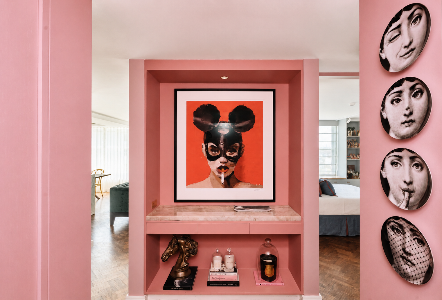 Bold entry gallery at Onslow Residence featuring blush pink architectural joinery, curated artwork, decorative wall plates and contemporary luxury styling by Luis La Pegna.
