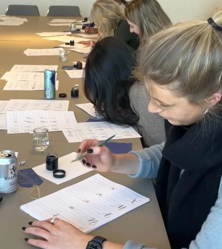 employees learning calligraphy at work
