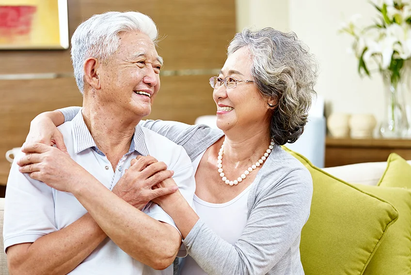 Older couple embracing on a couch