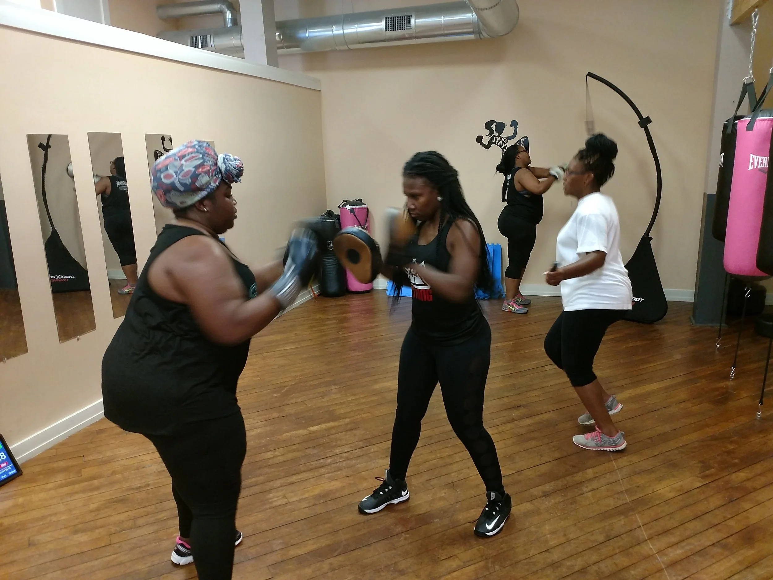 Latesha Strickland, center, trains Janiel Brown during a workout Tuesday at PittFit SheBox gym while Janessa Gardner (white shirt) and Jahnesee Farris do individual exercises. Photo by Junious Smith III / Neuse News