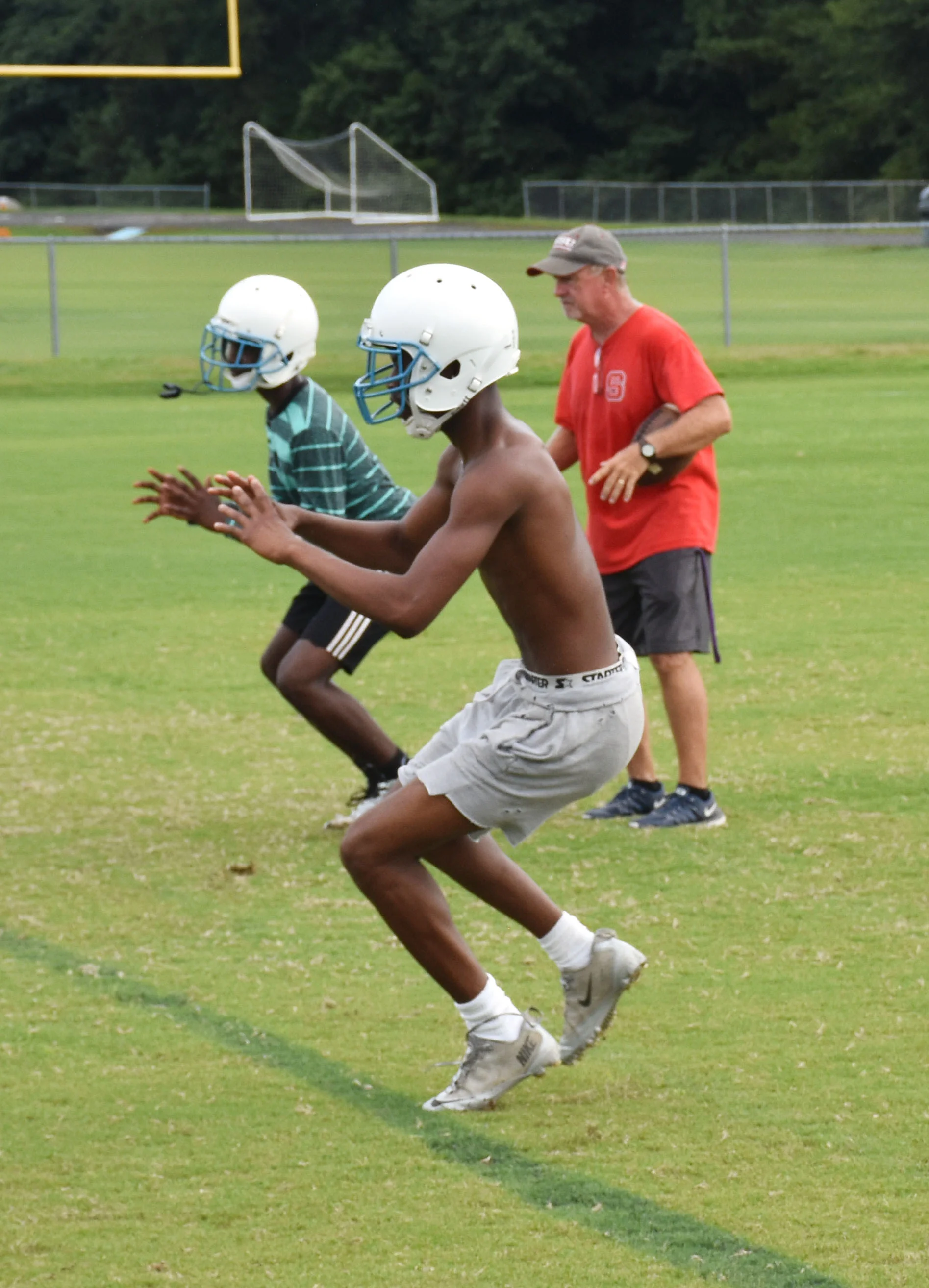 South Lenoir assistant football coach Donald Mooring guides the Blue Devils during Monday morning's practice in Deep Run. Photo by Bryan Hanks / Neuse News