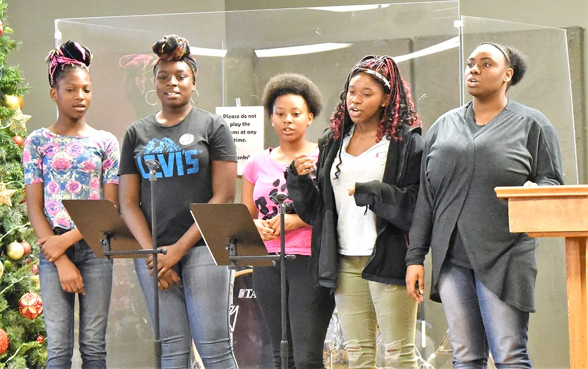 God's Gift -- an a capella group from The Gate -- sings at Saturday's ceremony. Photo by William 'Bud' Hardy / Neuse News
