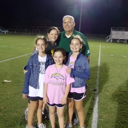 Coach Cornwell, his wife Carrie and their children. Photo by Scott Cole / Neuse News