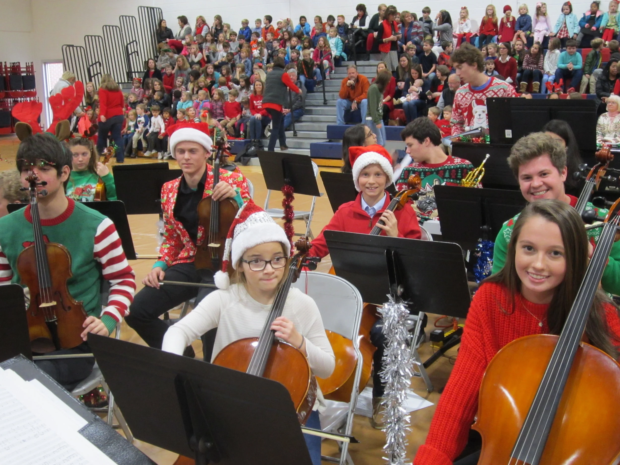 Reindeer antlers and Santa hats jolly up the APA student orchestra for its Holiday Concert performance.