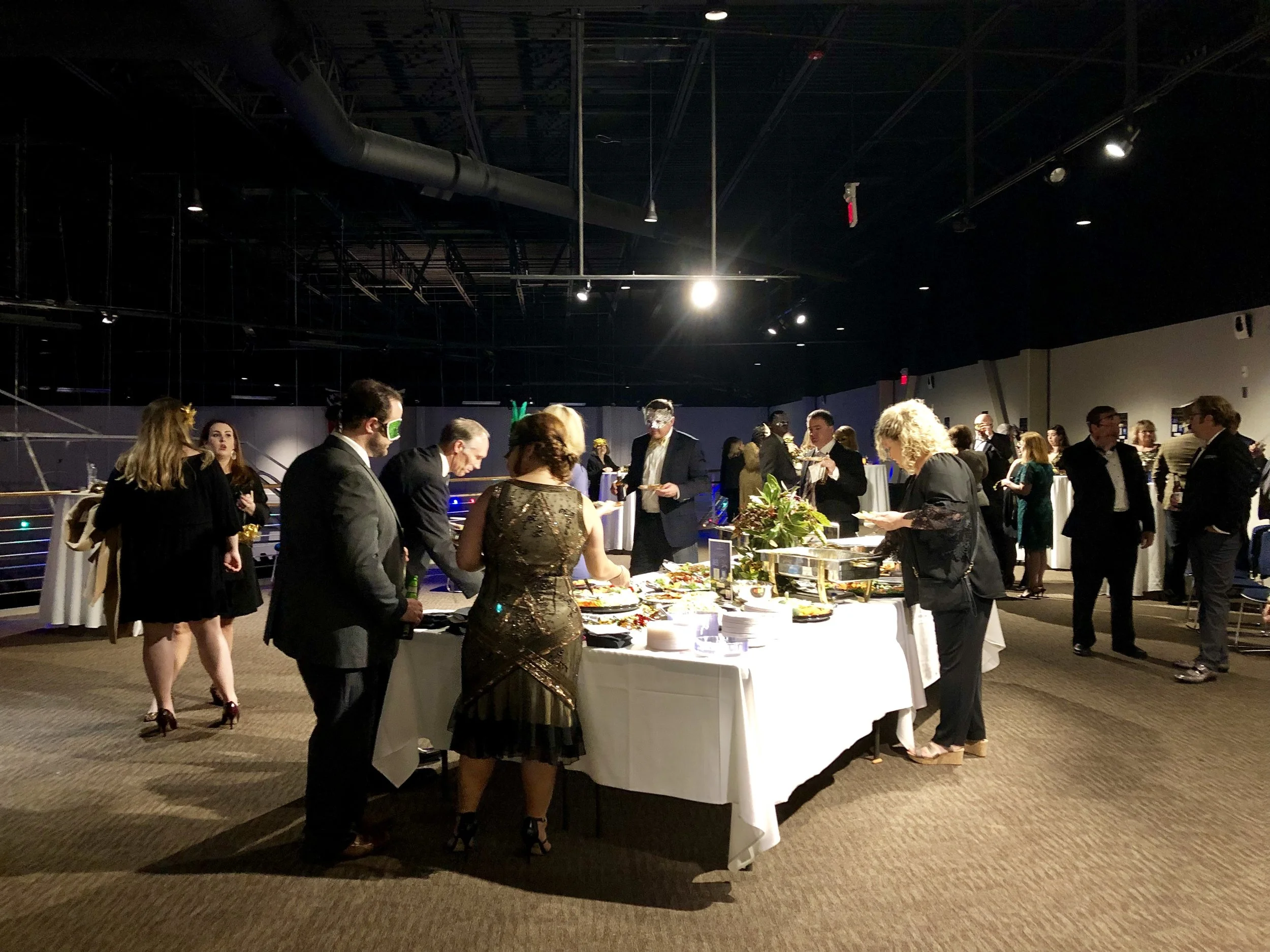 Guests select hors d’oeuvres at the NYE Masquerade. Photo by Catherine Hardee/Neuse News