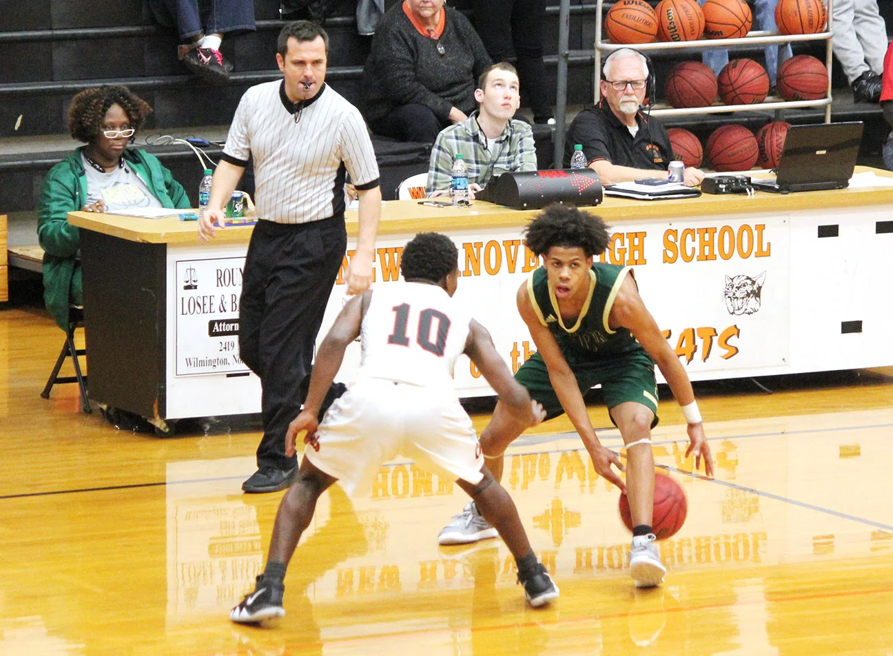 Kinston junior point guard Isaac Parson goes between his legs against