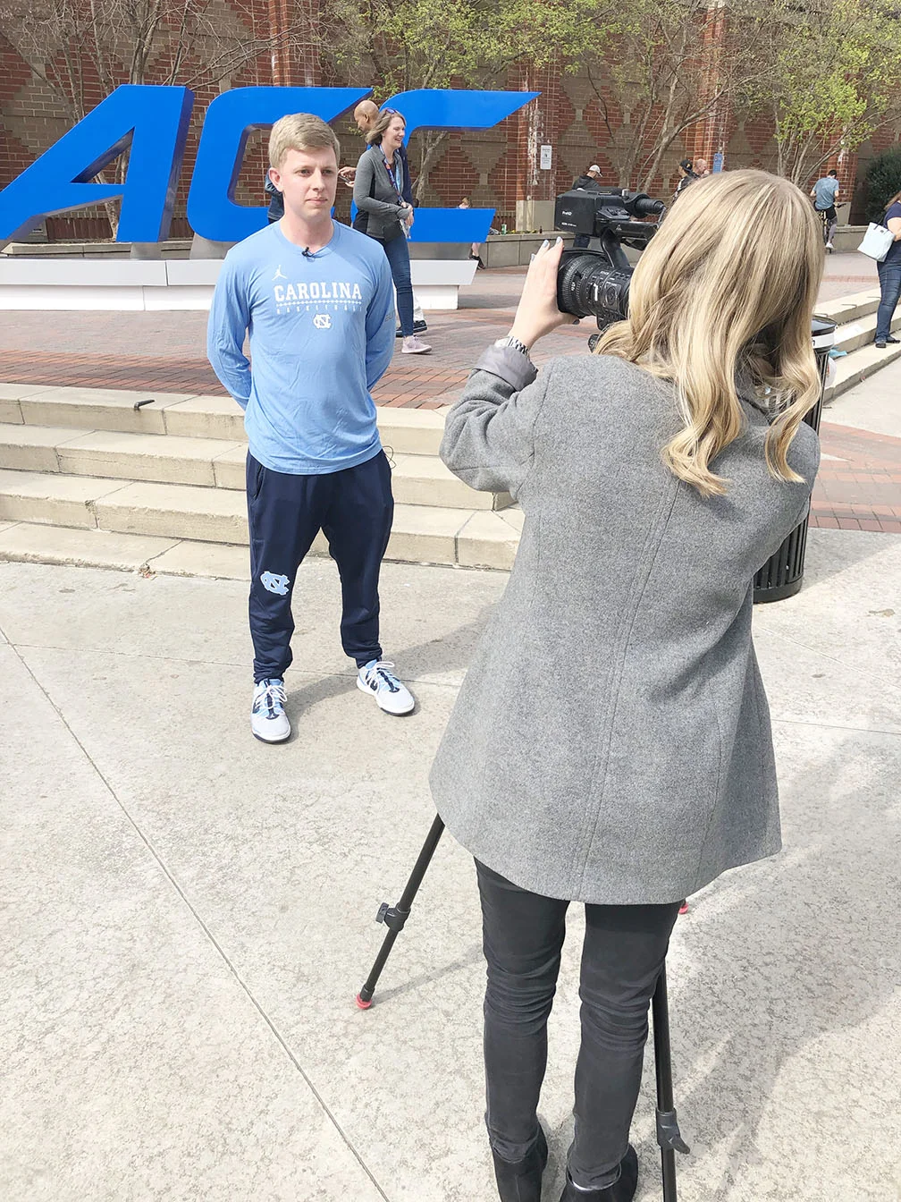 UNC men’s basketball manager Tyson Creech prepares to be interviewed by WCTI ABC-12’s Ariel Epstein outside the Spectrum Center in downtown Charlotte. Photo by Bryan Hanks / Neuse News
