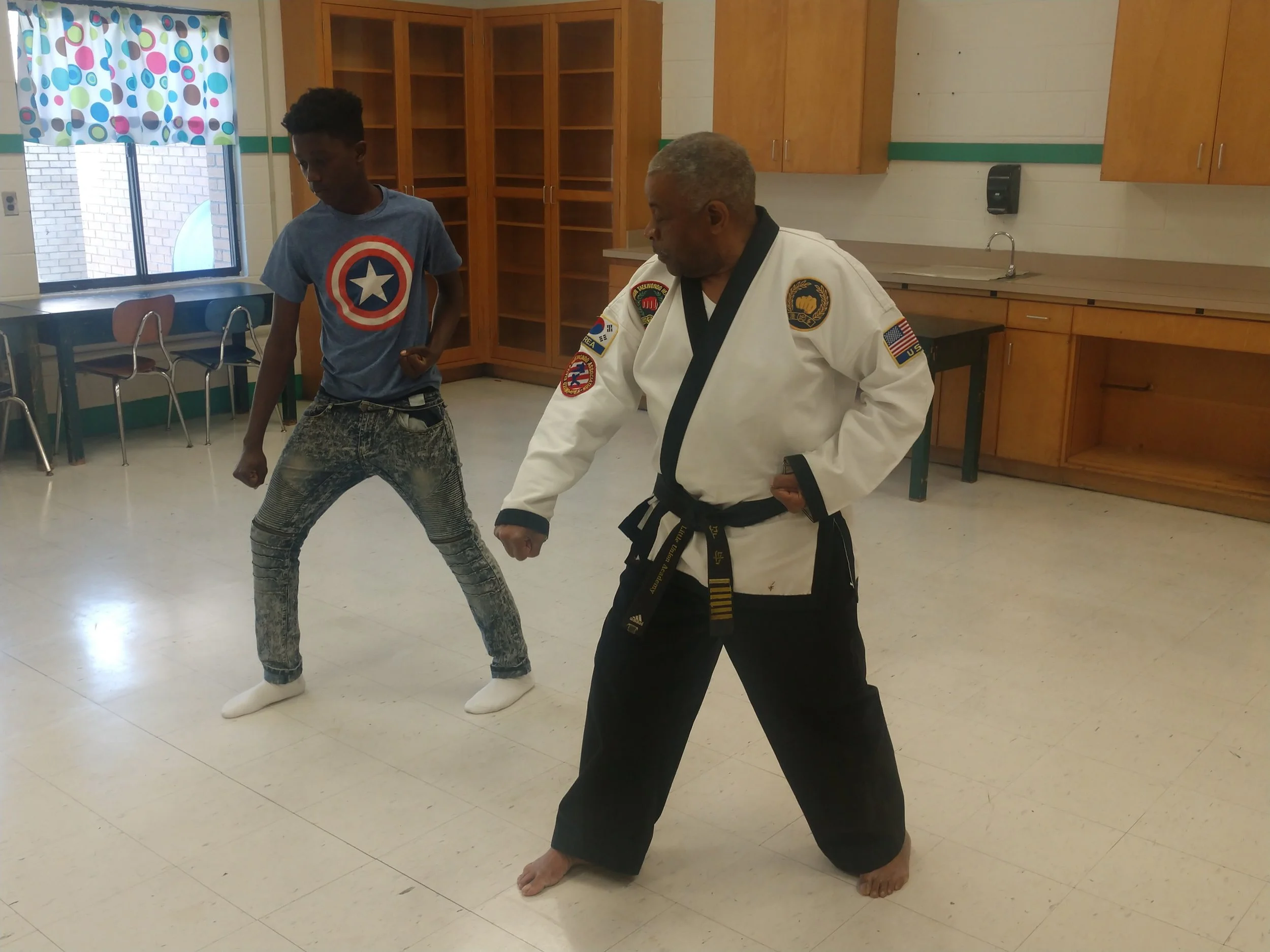 Master Joseph Jones goes over Tae Kwon Do techniques with Rochelle Middle seventh-grader Yazmere Hatch during a class at the school. Photo by Junious Smith III / Neuse News