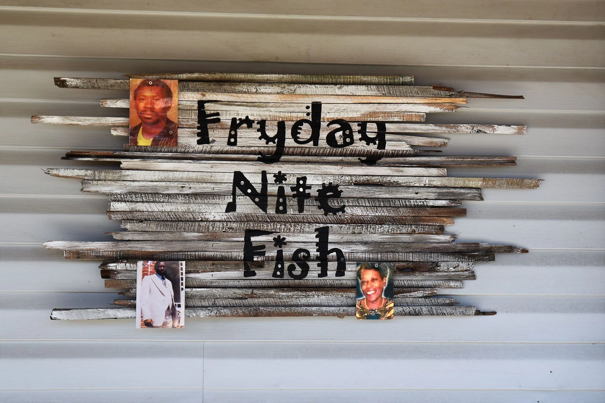 Pictures of family who have inspired the restaurant adorn the sign at Fryday Nite Fish.