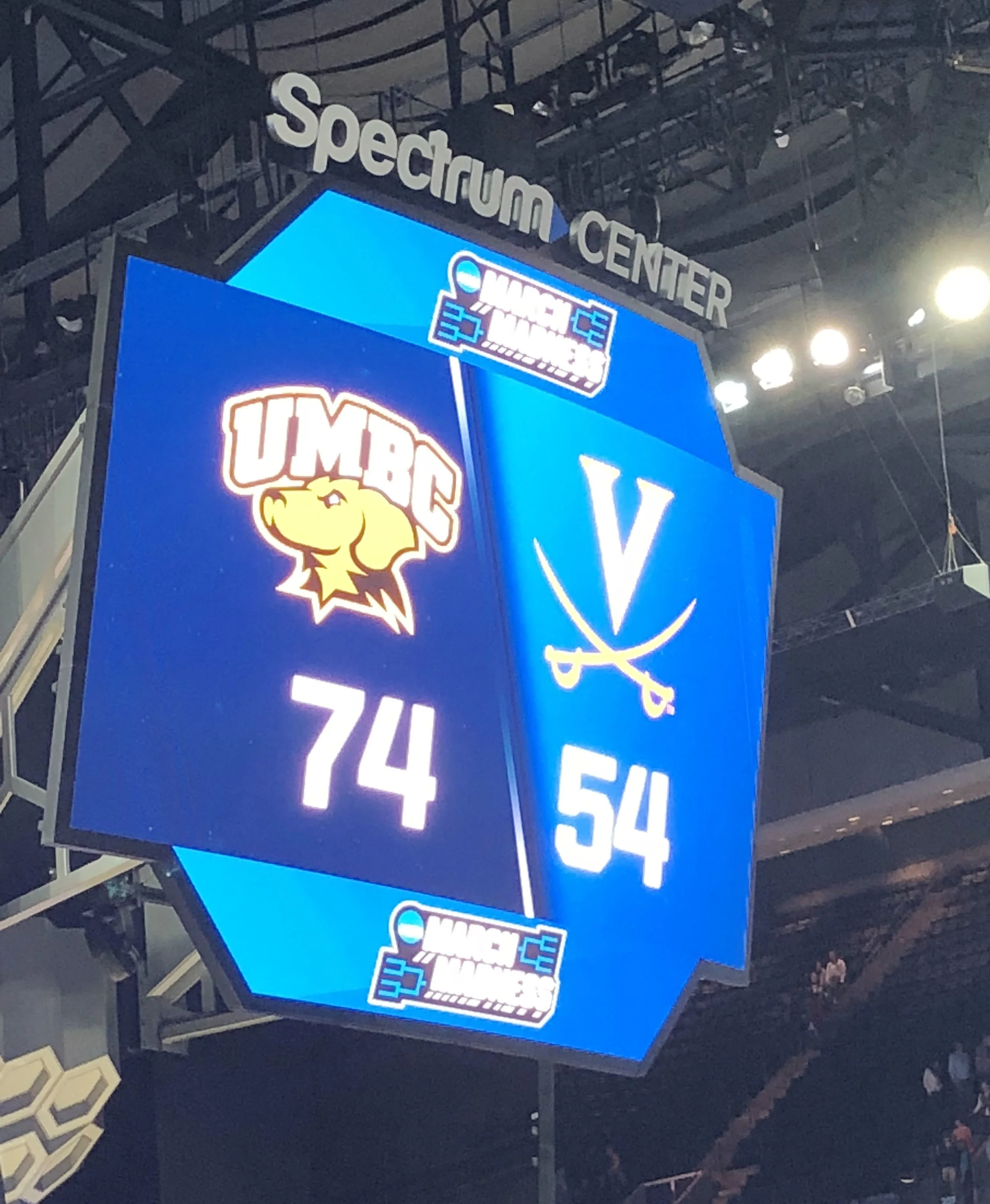 This was arguably the darkest sports moment in the writer’s life — when UMBC defeated his beloved Cavaliers in the 2018 NCAA Tournament on March 16, 2018. It was the first time in tourney history a 16-seeded team had knocked off a No. 1 seed. Photo taken through tears by the writer on press row at Charlotte’s Spectrum Center