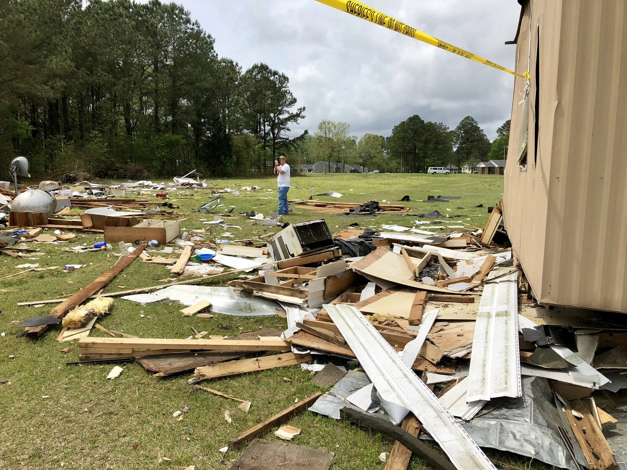 A fire official photographs the debris from the house explosion. Photo by Catherine Hardee / Neuse News