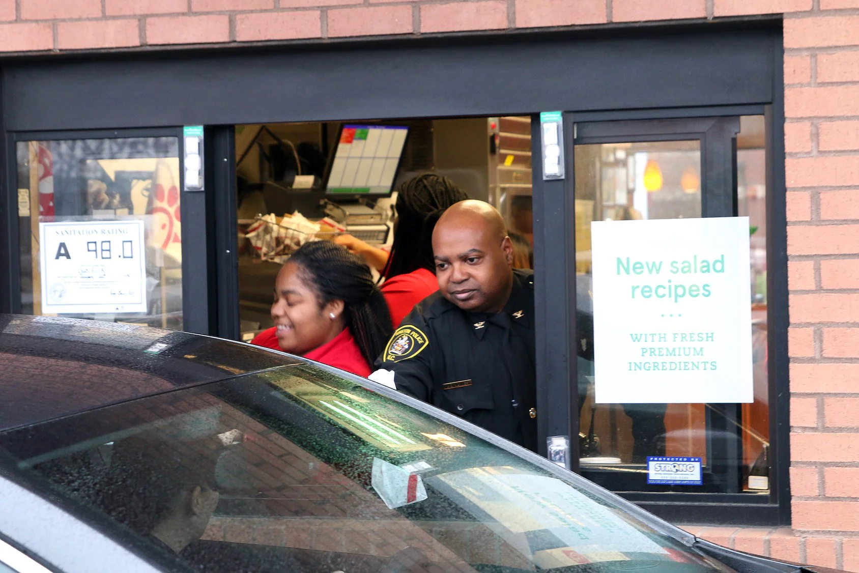 Kinston Police Chief Alonzo Jaynes works the drive thru window during a community relations event held at Chick-fil-A. Submitted photo.