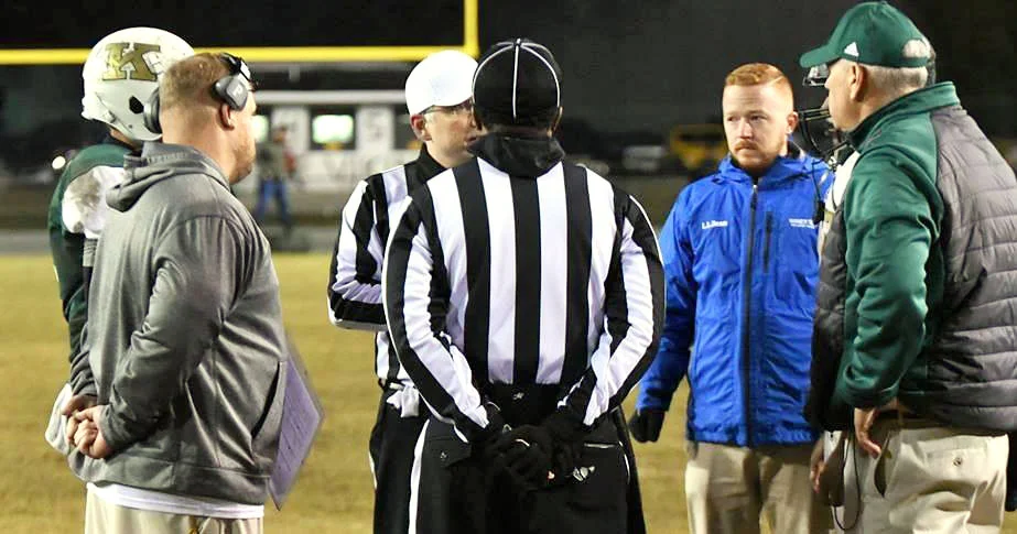 Kinston’s Ryan ‘Diesel’ Gieselman, left, and Ayden-Grifton’s Paul Cornwell, right, meet a midfield before an overtime playoff game last November. Photo by William ‘Bud’ Hardy
