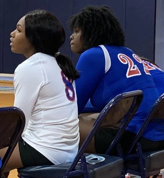Libero Amber Speight (8) and middle hitter Angel Hill watch their teammates during second-set action against Greene Central on Tuesday afternoon.