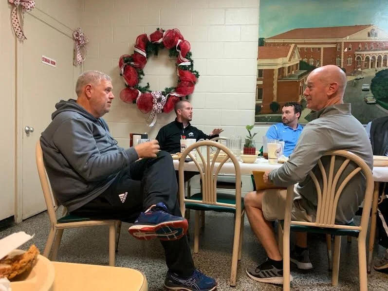 Ayden-Grifton’s Paul Cornwell, left, tournament director for the Parker’s Holiday Classic, talks with D.H. Conley head basketball coach Rob Maloney on Monday evening. Rudy Coggins/Neuse News