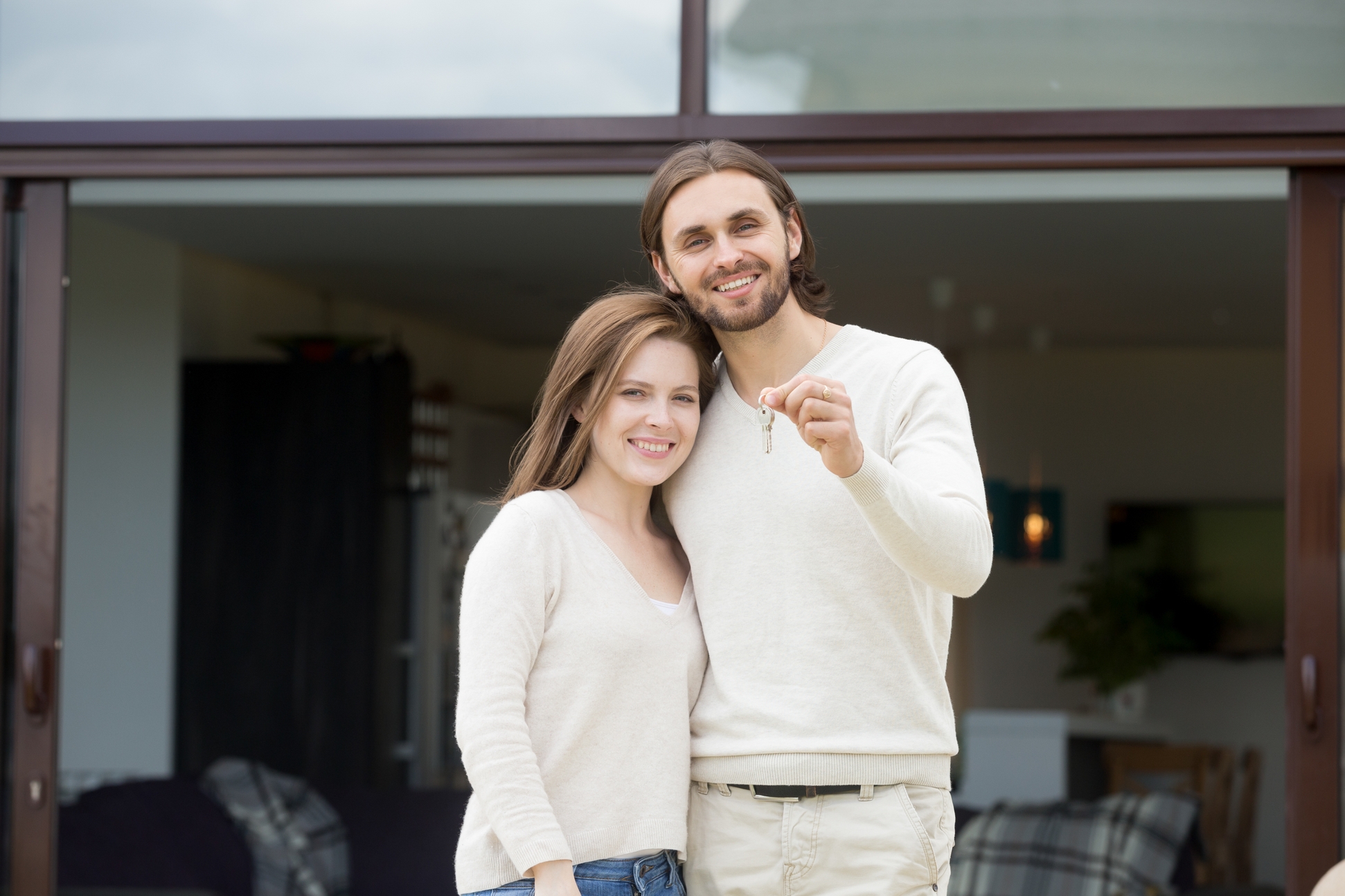 082953869-happy-couple-homeowners-holdin.jpeg