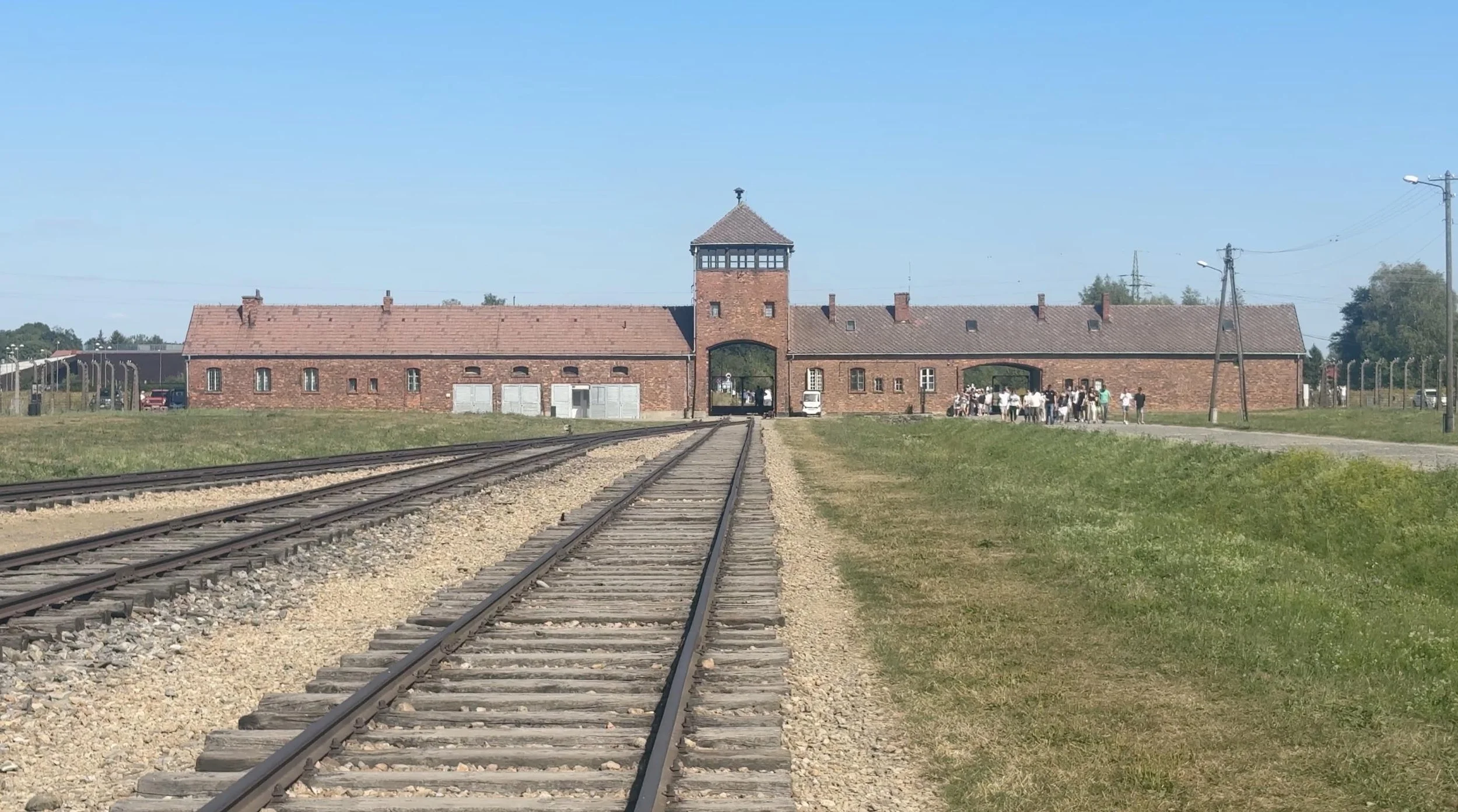 Railway tracks leading toward the gatehouse at Auschwitz II-Birkenau in Poland