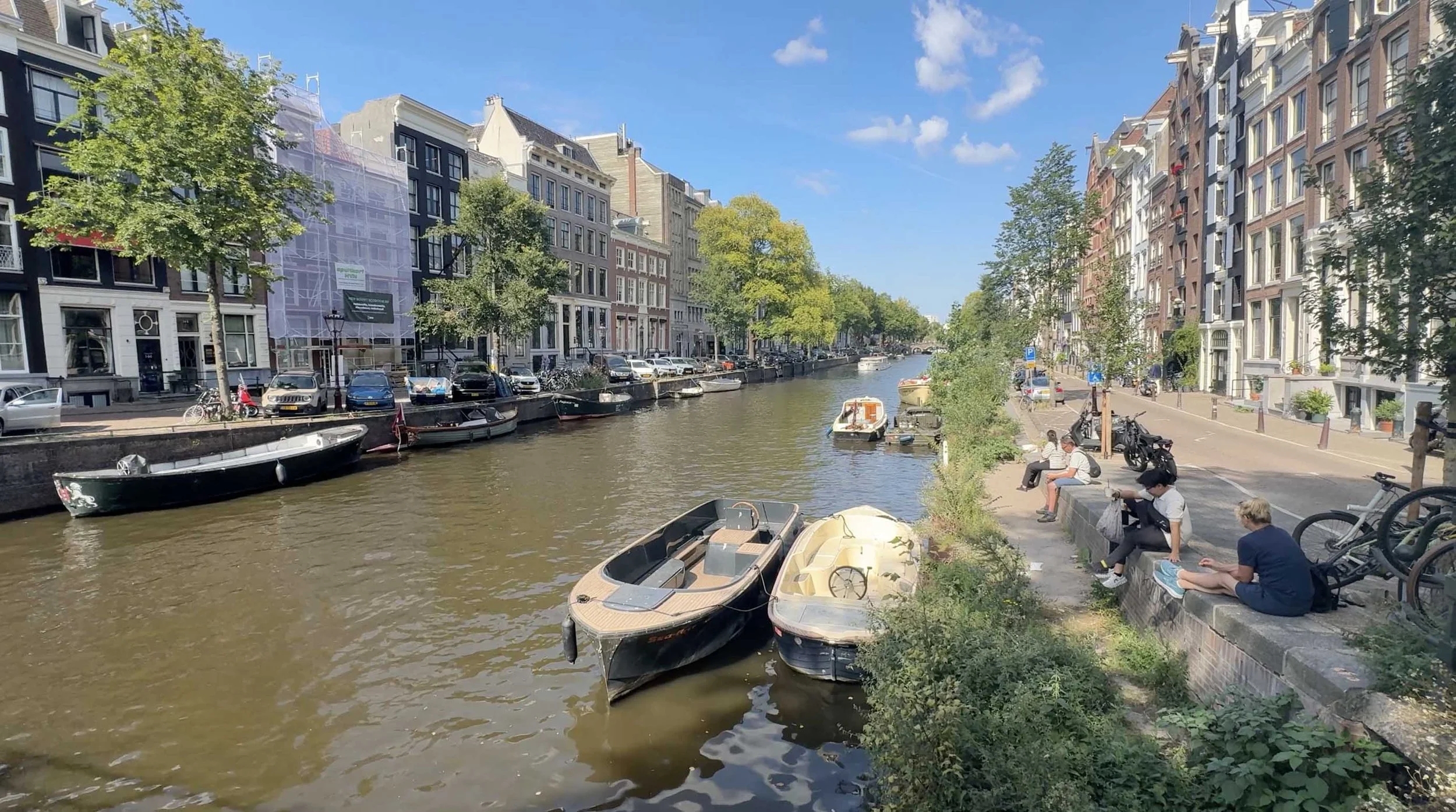 Canal lined with historic buildings, bicycles and boats in Amsterdam, Netherlands