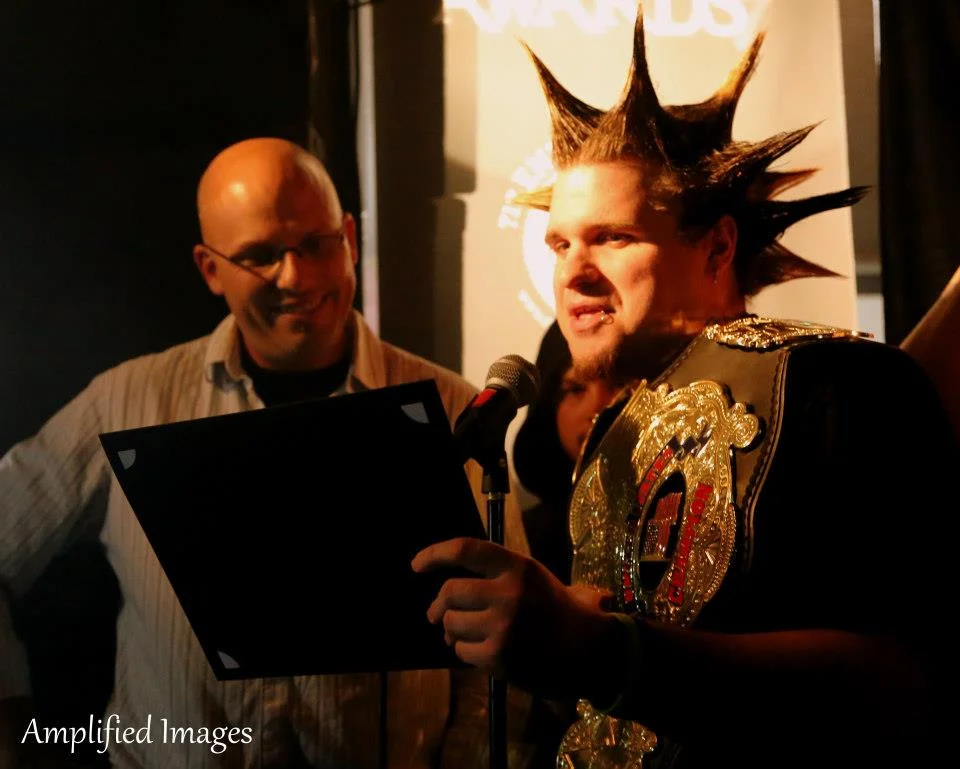 Rob Simon of 105.7 The X and Justin Mack of the UWE present an award. *Photo Credit: Amplified Images