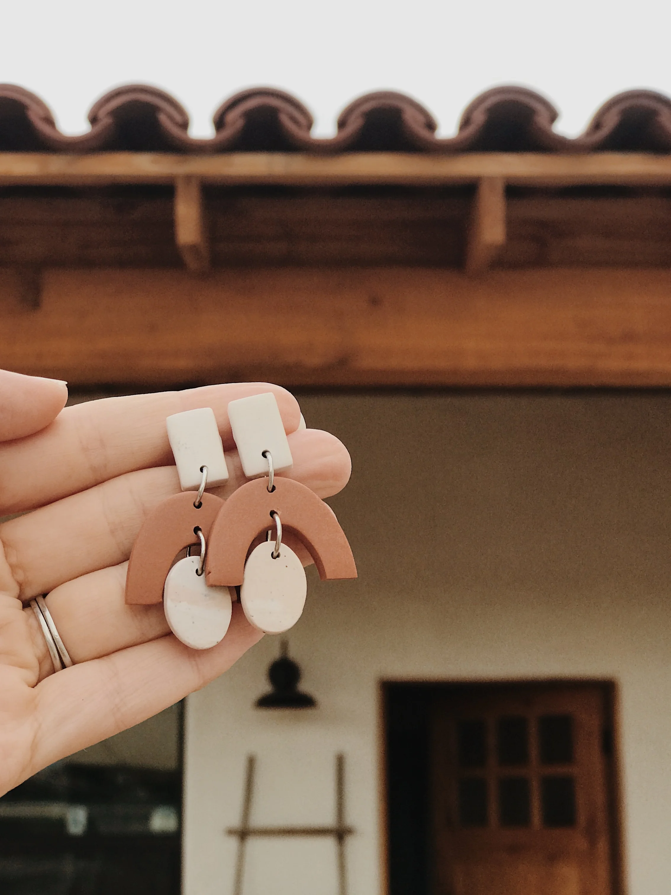 These earrings are a nod to the “blush” floors and the arch and color of the terra cotta roof tiles.