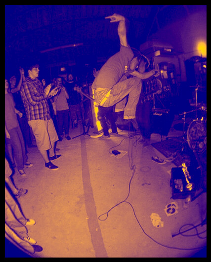 Taking a leap during a performance in Baton Rouge, LA at The Warehouse at HTGT Thrift