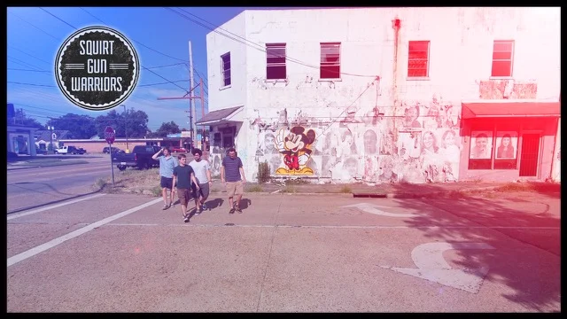 Still shot of the band from the video with logo added